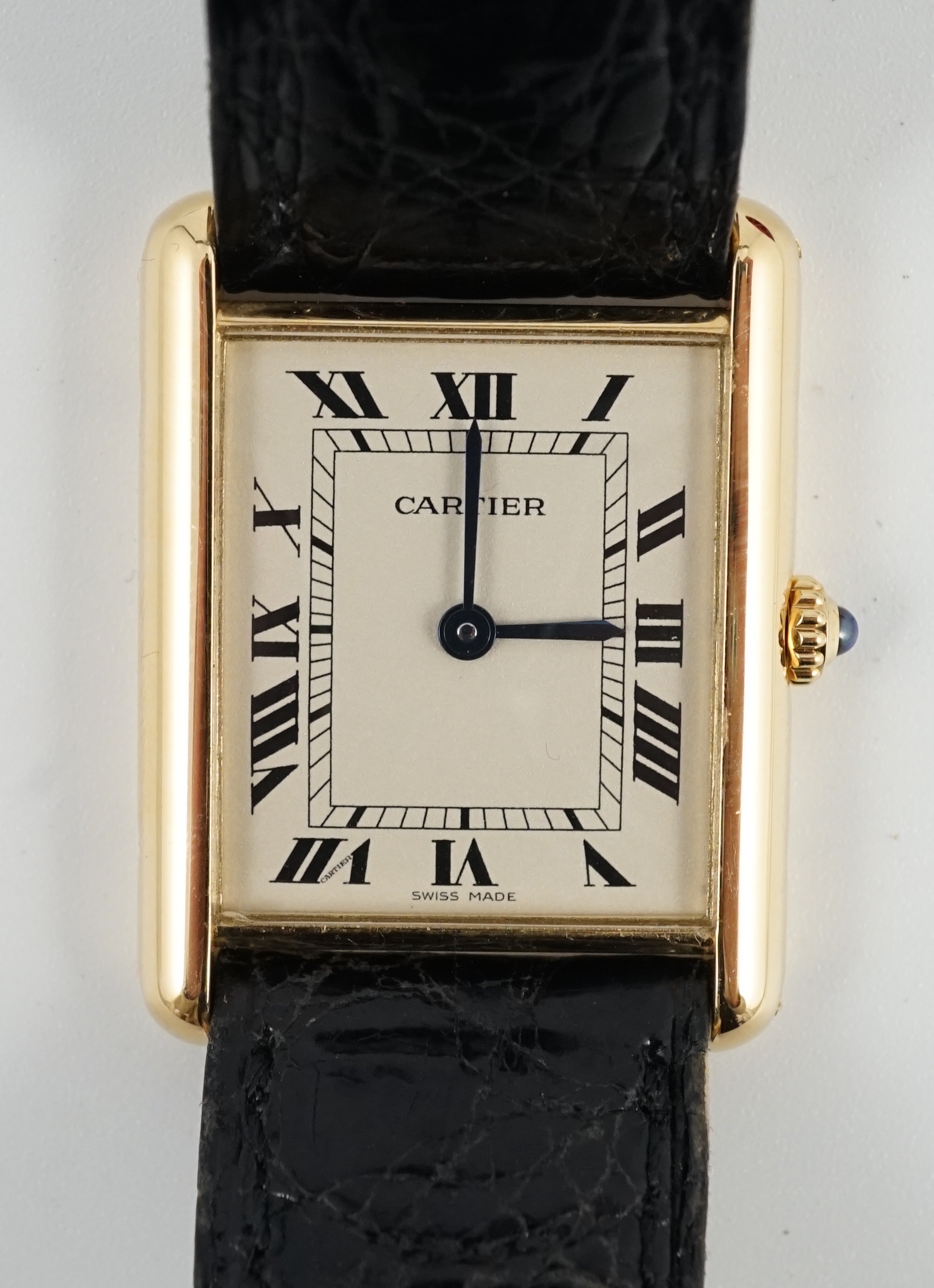 A gentleman's 18ct gold Cartier Tank quartz wrist watch, on a Cartier leather strap with Cartier 18ct gold buckle